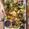 Baked feta with radishes, potato and harissa dressing