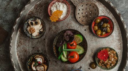 Side dishes with pickled fruits yoghurt cheese on vintage tray with ornaments