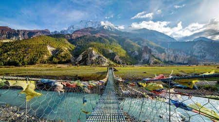 Suspension bridge with buddhist prayer flags Annapurna